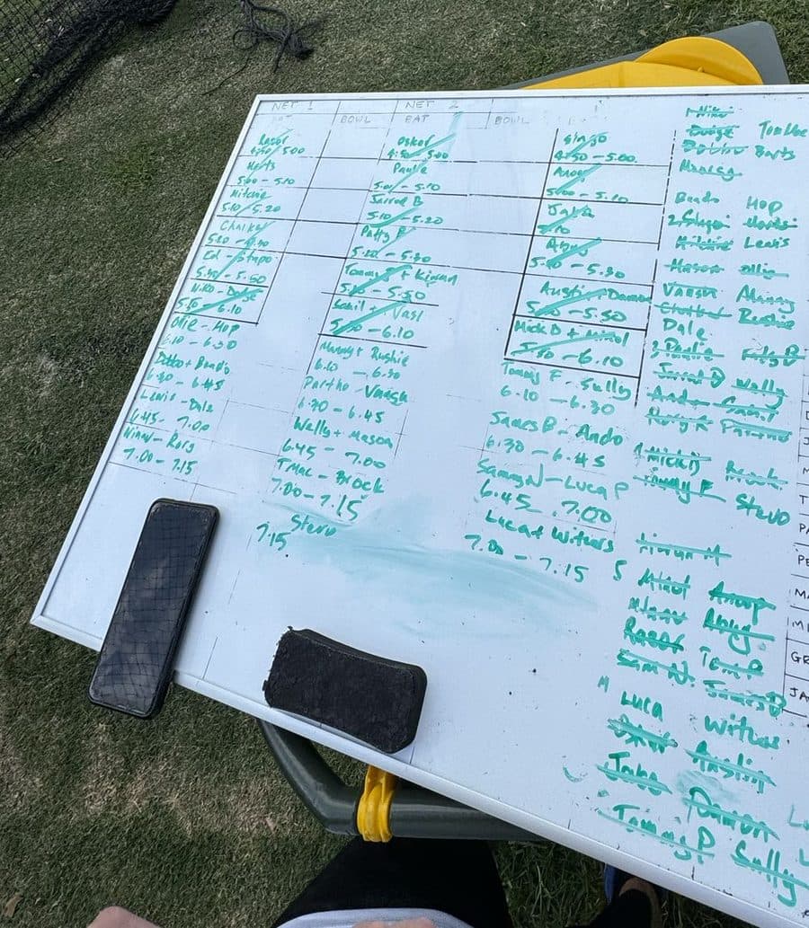 A club whiteboard covered in batting and bowling times